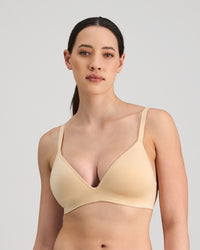 Model wears Simply Seamless Wire Free Bra in Nude. On body front view