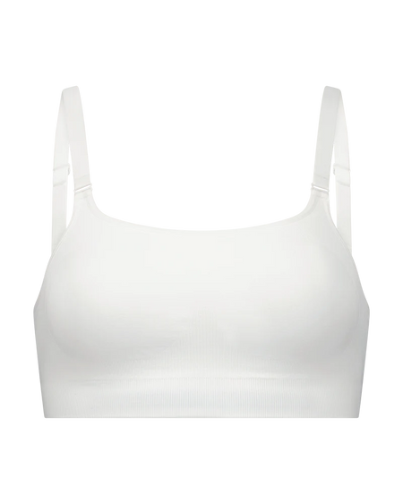 White crop top with thin straps on a white background
