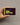 Hand holding a 'Bendon Bra Better' product packaging against a gray background