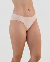 Model wears Seamless Soft Bikini in LATTE. On body side view