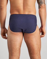 Model wears Cotton Stretch Mens Brief in PEACOAT PINSTRIPE. On body back view