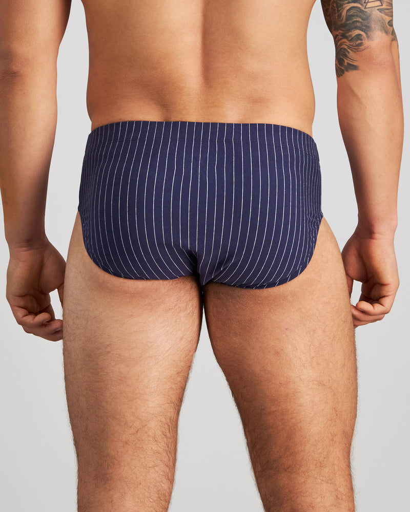 Model wears Cotton Stretch Mens Brief in PEACOAT PINSTRIPE. On body back view
