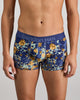 Model wears Retros Print Mens Trunk in WILD CAMO PRINT. On body front view