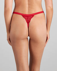 Model wears Lace Me Up Thong in JESTER RED. On body back view