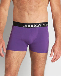 Model wears Everyday Essential Mens Trunk in PURPLE MAGIC. On body front view