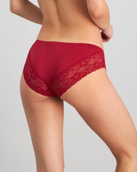 Model wears Lace Trim Brazilian in BIKING RED. On body back view