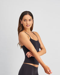 Model wears Simply Seamless Camisole in BLACK. On body side view