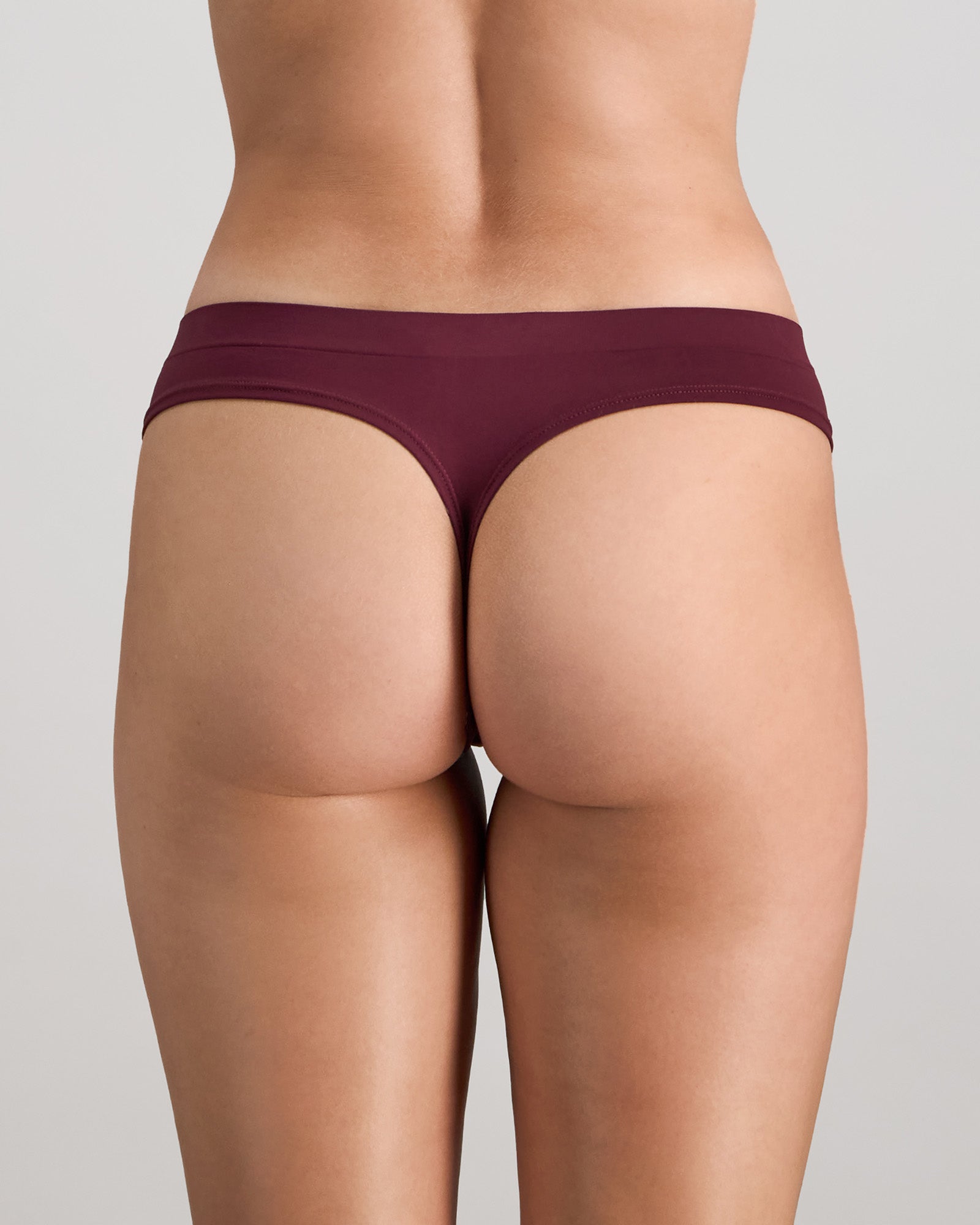 Model wears Seamless Soft Thong in FIG. On body back view