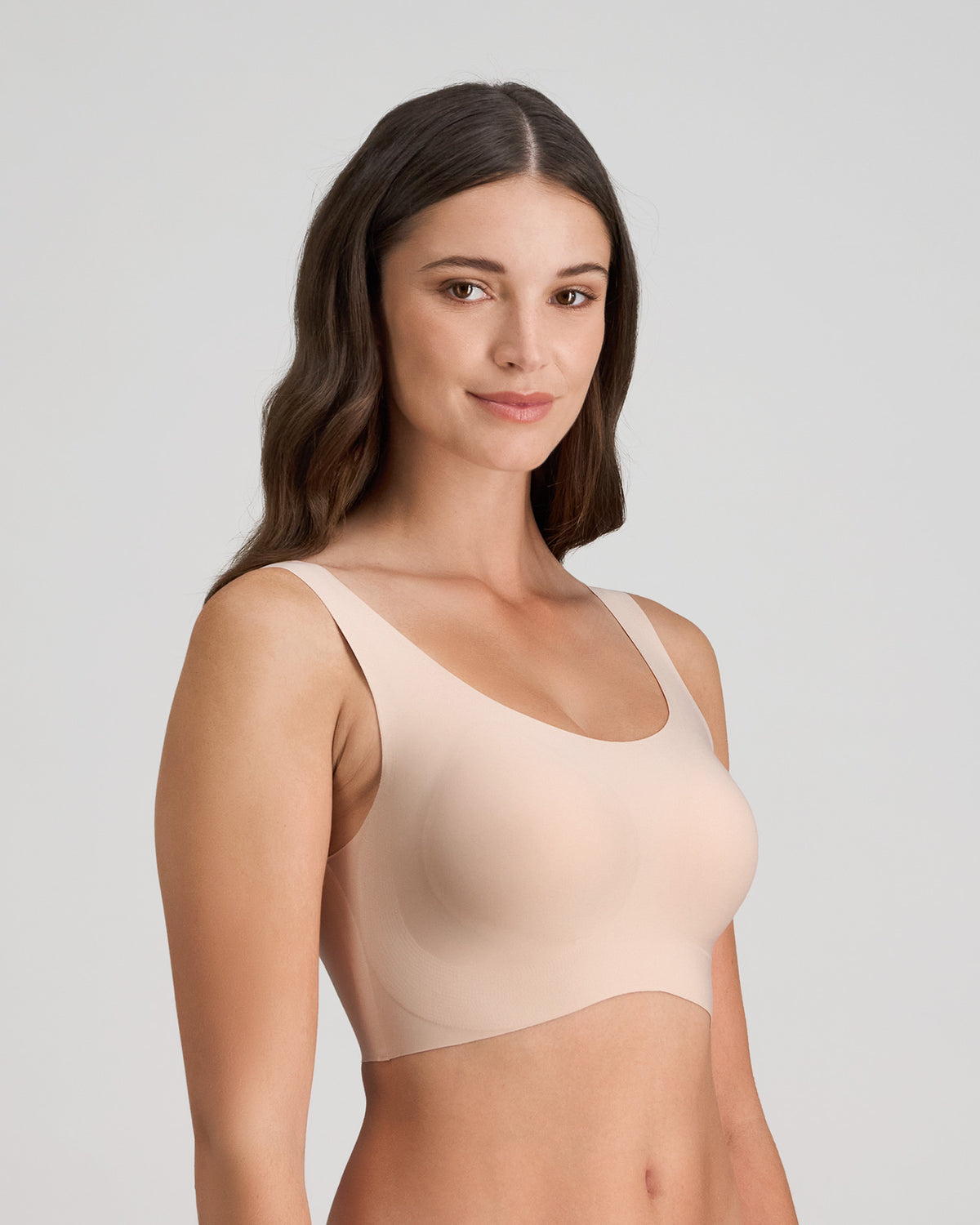 Model wears Comfit Collection Crop Top in LATTE. On body side view