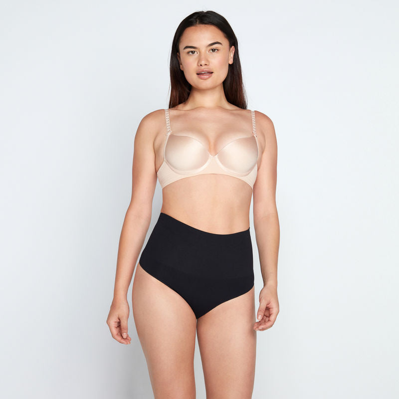 Model wears Medium Control Thong in BLACK. On body front view