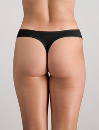 Model wears Extra-Ordinary Thong in BLACK. On body back view