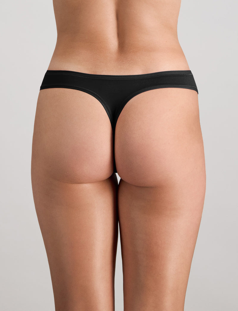 Model wears Extra-Ordinary Thong in BLACK. On body back view