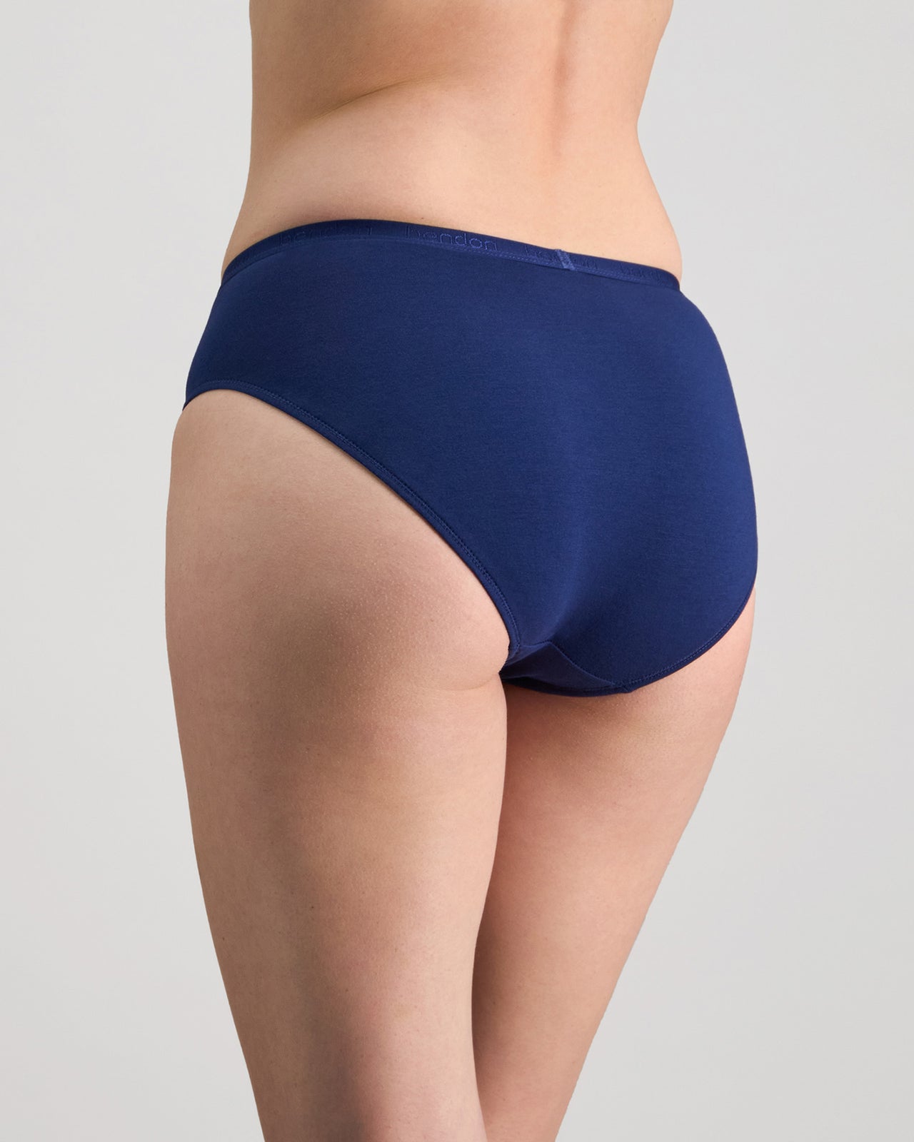 Model wears Body Cotton Bikini in Medieval Blue. On body back view