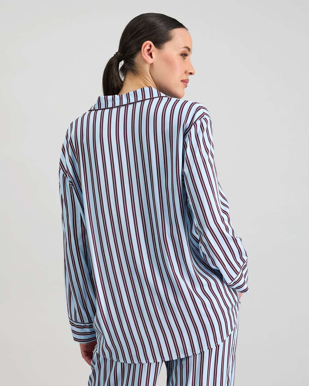 Model wears Cabana Stripe Long Sleeve Pj Top in COOL BLUE. On body back view