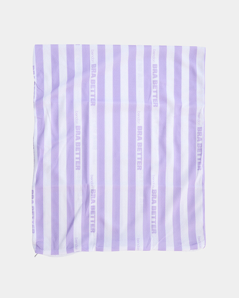 Model wears BB Stripe Wash Bag in STRIPE. On body back view