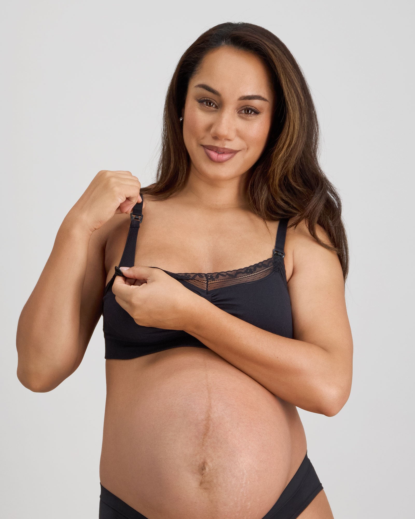 Model wears Bendon Nurture Maternity Bra in BLACK. On body side view