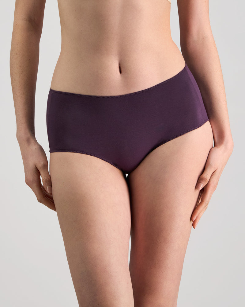 Model wears Au Naturel Full Brief in PLUM PERFECT. On body front view