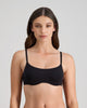 Model wears Extra-Ordinary Contour Bra in BLACK. On body front view