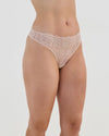 Model wears All Lacey Thong in LATTE. On body side view