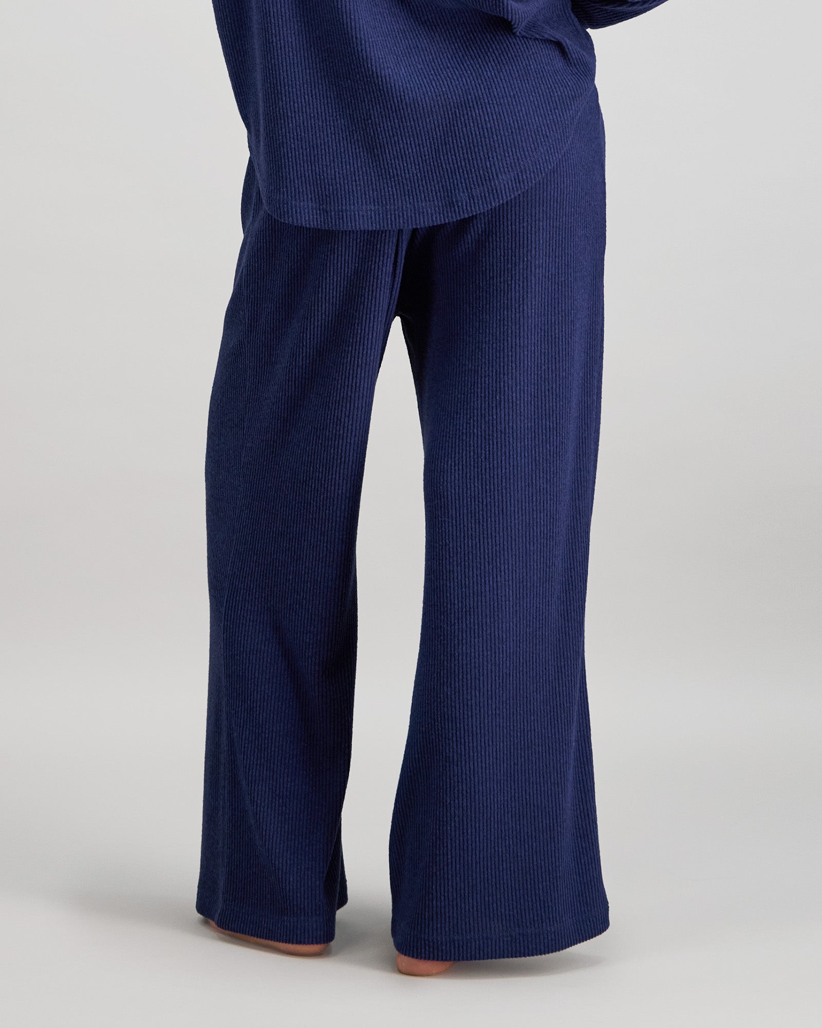 Model wears Relaxed Rib Long Pj Pant in NAVY BLAZER. On body back view