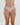 Model wears Stretch Cotton Thong in LATTE. On body front view
