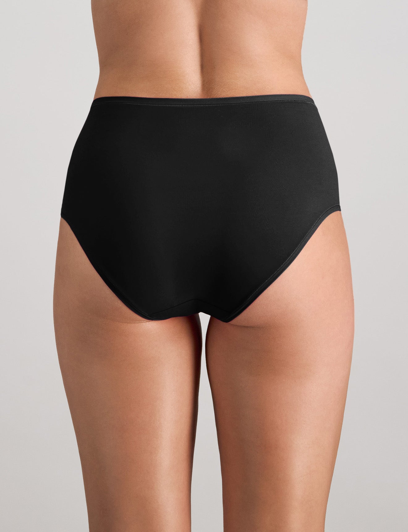 Model wears Extra-Ordinary Full Brief in BLACK. On body back view