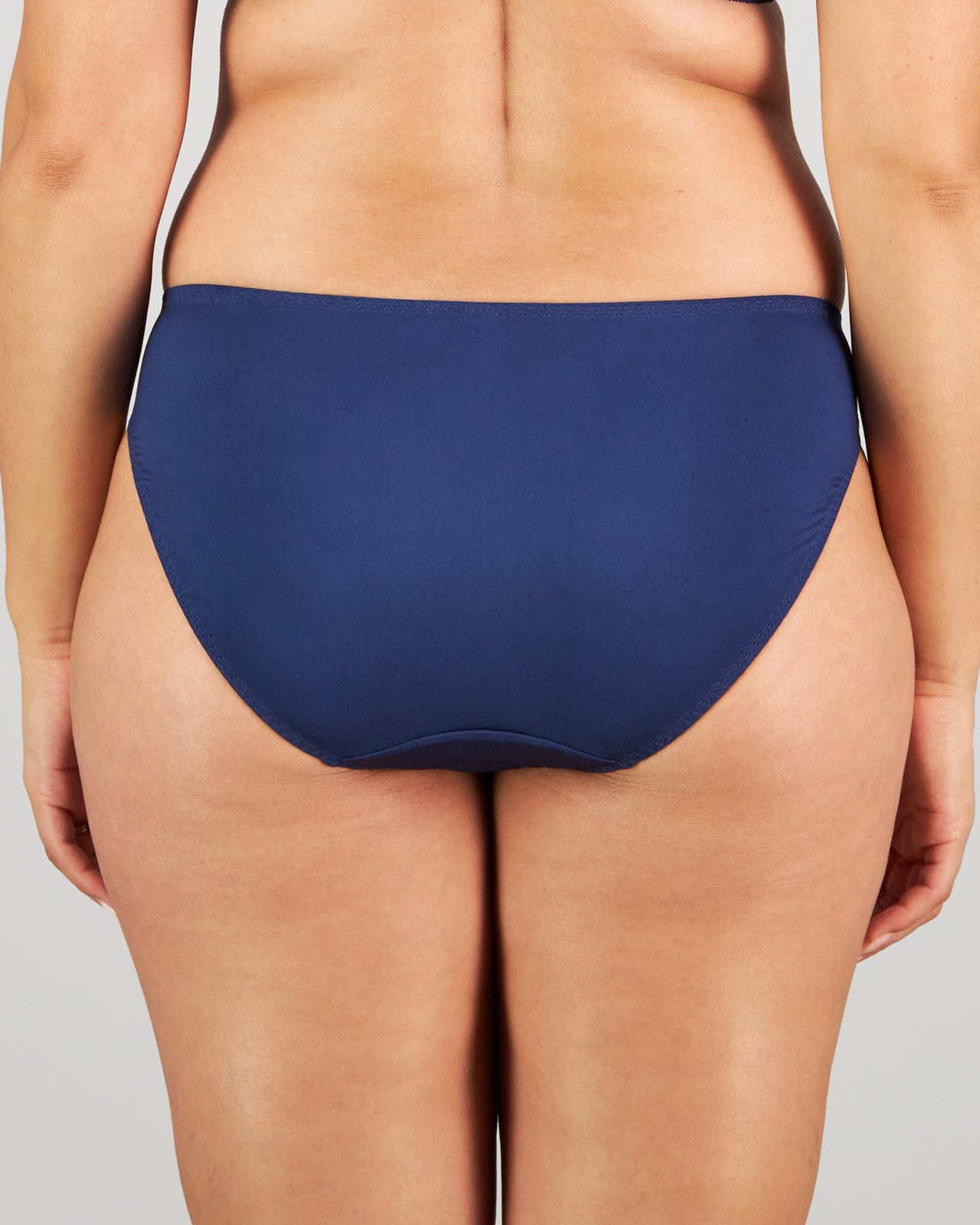 Model wears Eternal Bikini in Medieval Blue. On body back view