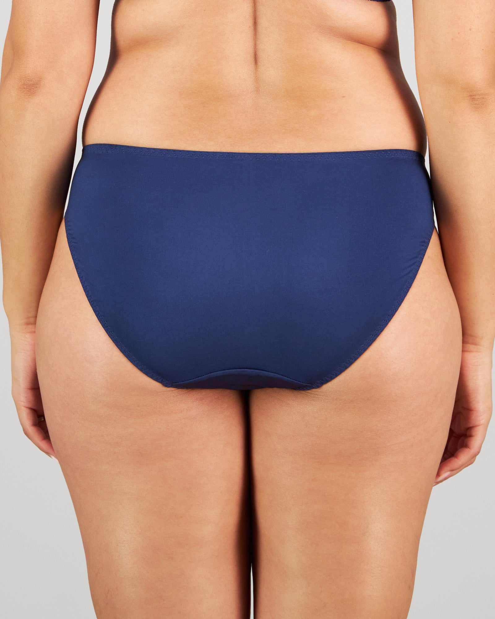 Model wears Eternal Bikini in Medieval Blue. On body back view