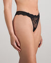 Model wears My Fit Lace Thong in BLACK. On body side view