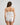 Model wears Body Cocoon Camisole in WHITE. On body back view