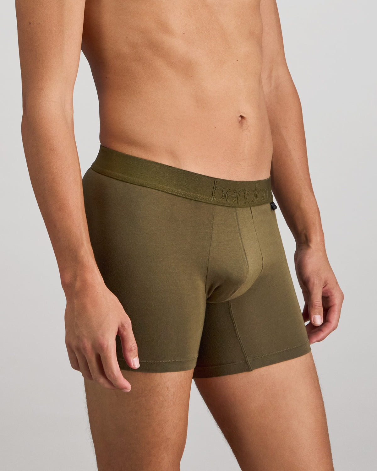 Model wears Bamboo Mens Trunk in DARK OLIVE. On body side view
