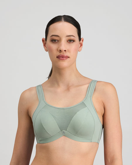 Model wears Power Underwire Bra in ICEBERG GREEN. On body front view
