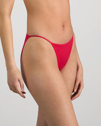 Model wears Skinlite Tanga in JAZZY. On body side view
