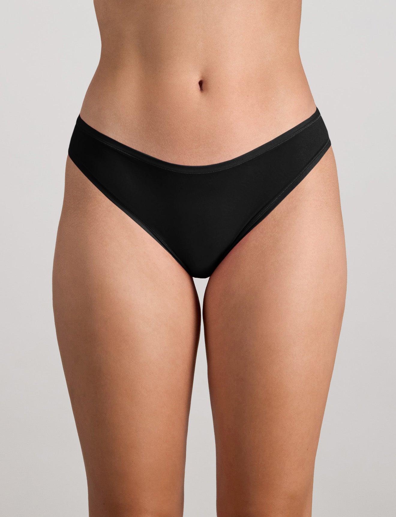 Model wears Extra-Ordinary Bikini Brief in BLACK. On body front view