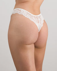 Model wears My Fit Lace Thong in WHITE. On body front view