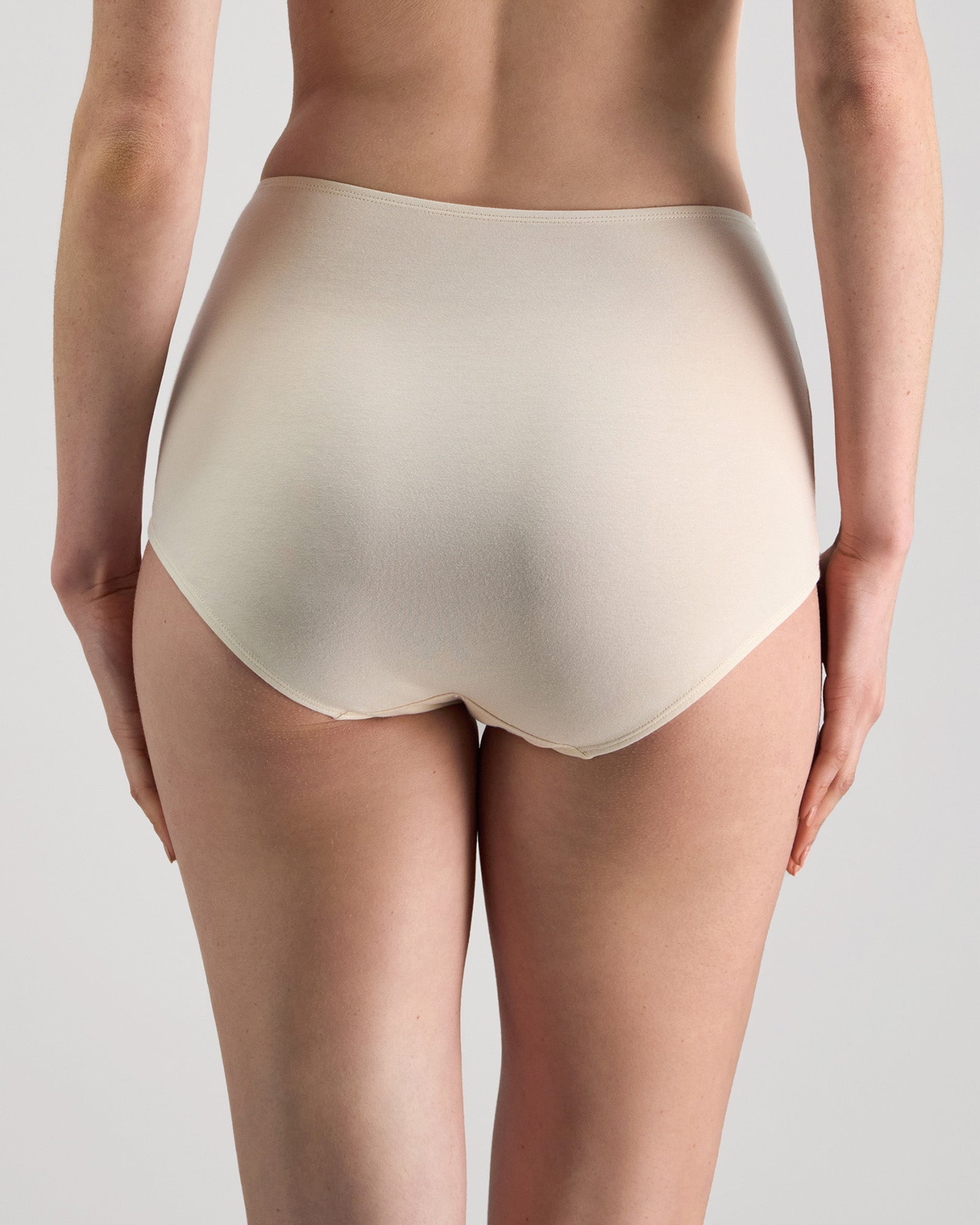 Model wears Freestyle Full Brief in CHAMPAGNE. On body back view