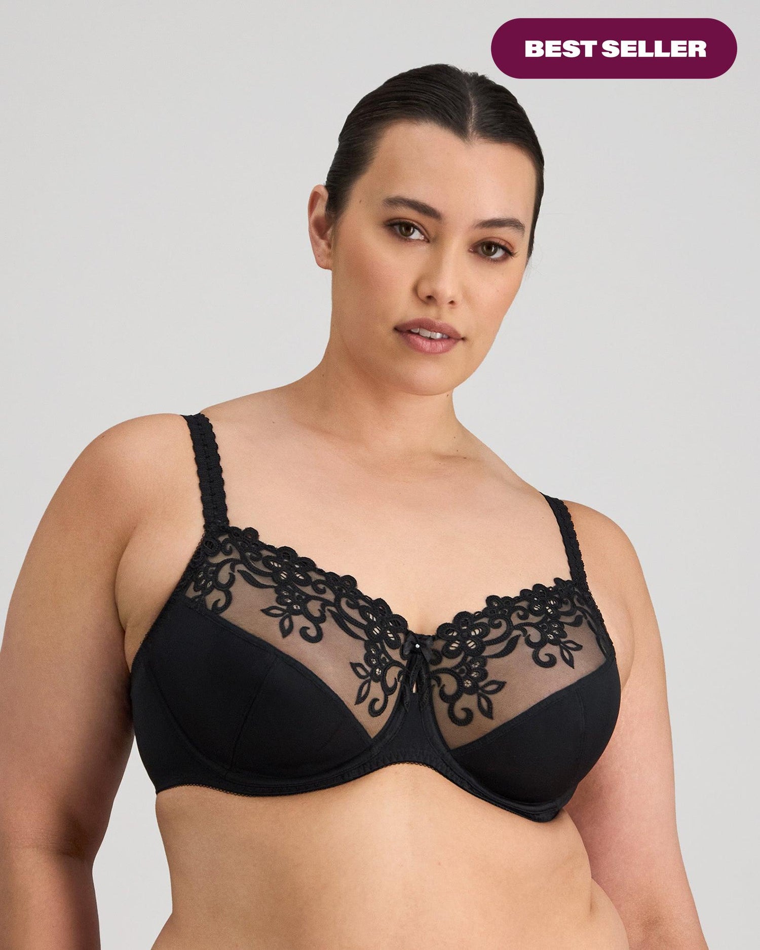 Model wears Coral Underwire Bra in BLACK. On body front view