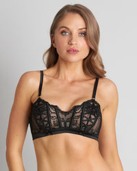 Model wears Lace Me Up Bralette in BLACK. On body front view