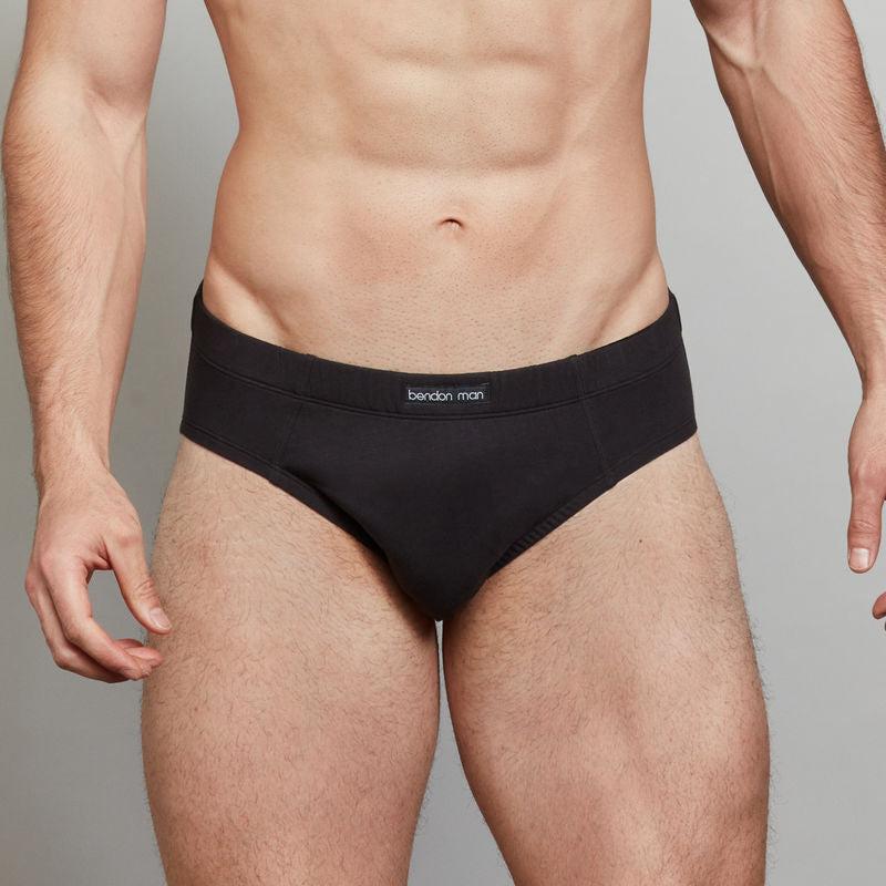 Model wears Cotton Stretch Mens Brief in BLACK. On body front view