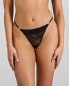 Model wears Lace Impact Thong in BLACK. On body front view