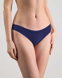 Model wears Extra-Ordinary Bikini Brief in Medieval Blue. On body side view