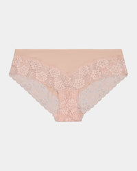 Model wears Lace Trim Brazilian in LATTE. On body front view