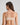 Model wears Extra-Ordinary Crop Top in LATTE. On body back view