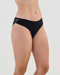 Model wears Cotton And Lace Bikini in BLACK. On body side view