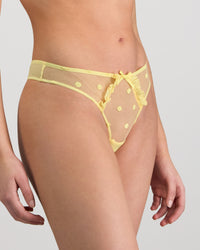 Model wears Sunlit Thong in LEMON MERINGUE. On body side view