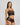 Model wears Oasis Glow Camisole in BLACK. On body side view