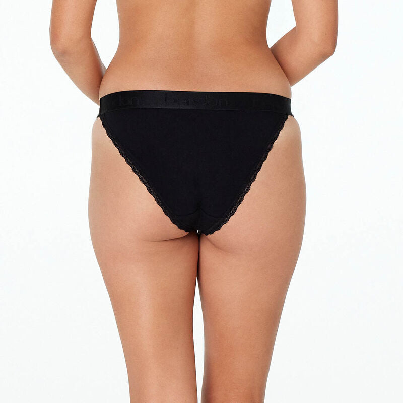 Model wears Cotton Logo Tanga in BLACK. On body back view