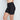 Model wears Everyday Light Hold Chafer Short in BLACK. On body side view