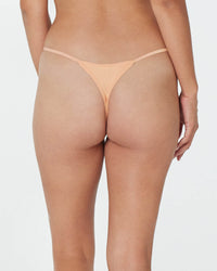Model wears Clemence Thong in LATTE. On body back view