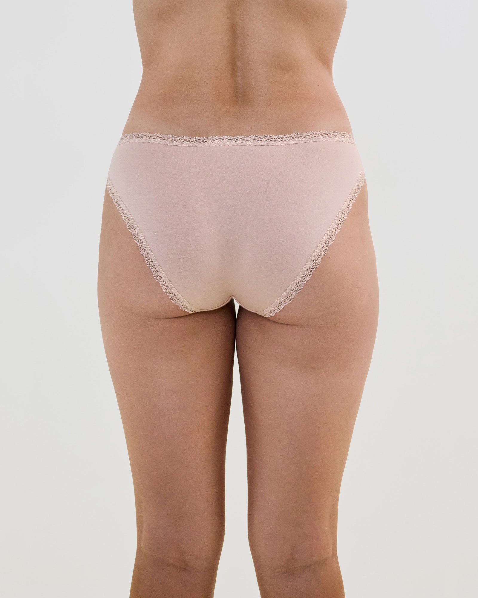 Model wears Stretch Cotton Bikini in LATTE. On body back view